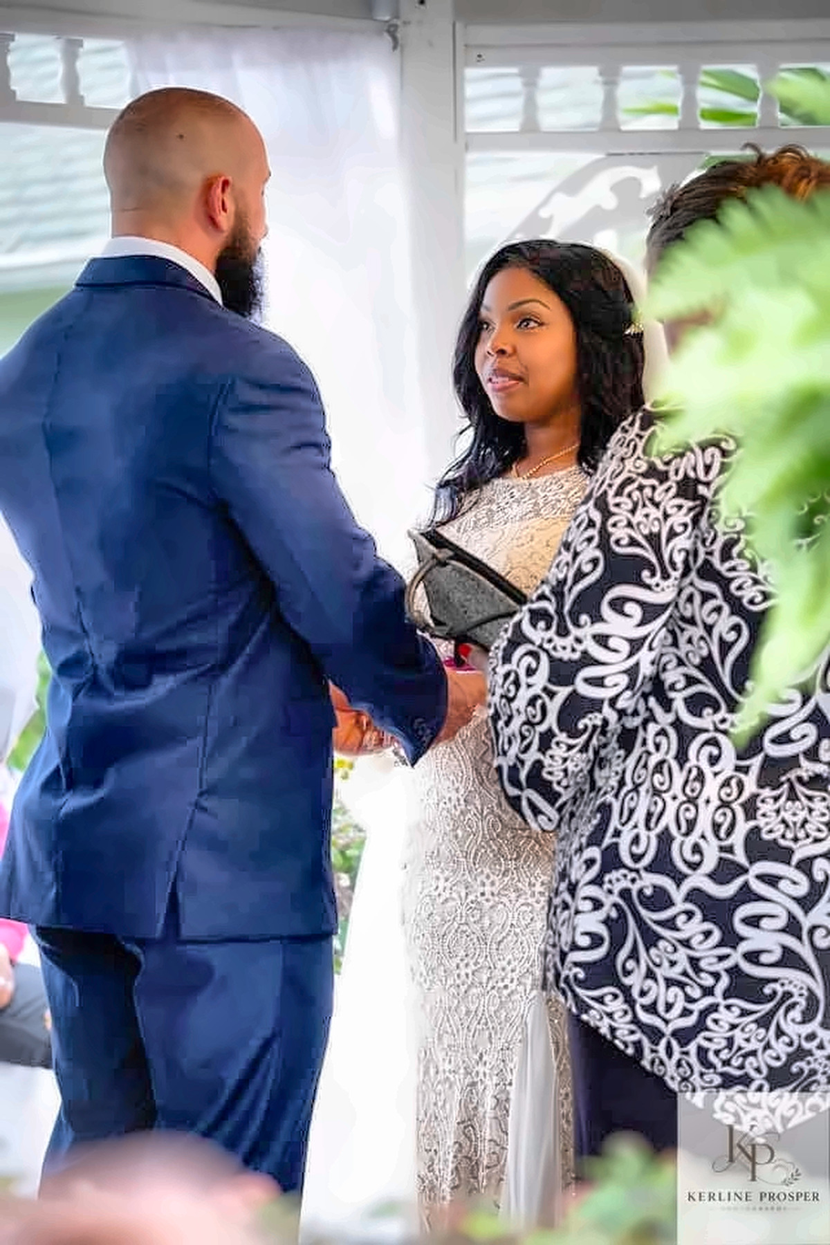 Couple holding hands during a wedding ceremony
