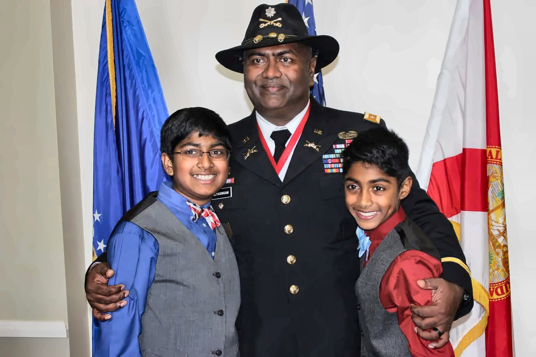 Father in dress uniform posing with two boys